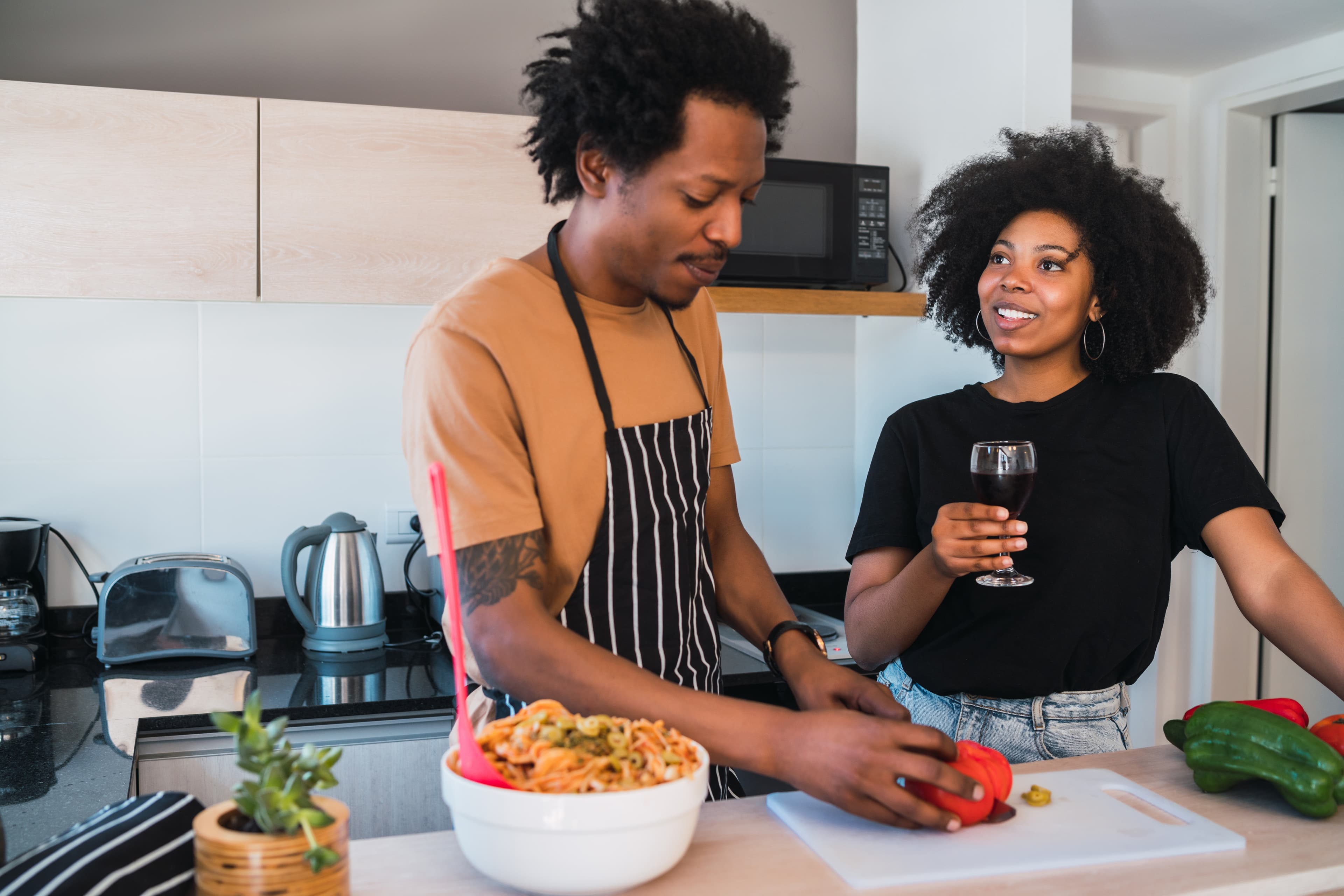 Person listening to podcasts while cooking in the kitchen